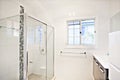 Modern white bathroom interior with glass shower Royalty Free Stock Photo