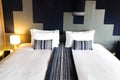 Modern White bed and dark blue pillow combination of vintage wooden bedroom Asian style Royalty Free Stock Photo