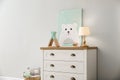 Modern white chest of drawers near light wall in child room. Interior design Royalty Free Stock Photo