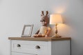 Modern white chest of drawers near wall in child room. Interior design Royalty Free Stock Photo