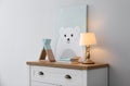 Modern white chest of drawers near light wall in child room. Interior design Royalty Free Stock Photo