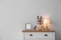 Modern white chest of drawers near wall in child room, space for text. Interior design Royalty Free Stock Photo