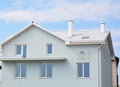 Modern white color house with unfinished balcony, attic skylight window, white tiles roof outdoors Royalty Free Stock Photo