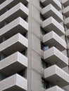 modern white concrete apartment block with geometric angular balconies