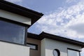 Modern white cottages with panoramic windows on the background of the park and blue sky Royalty Free Stock Photo