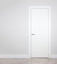 Modern white door. Grey wall with free space. Minimalist