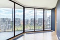 Modern white empty loft apartment interior with parquet floor and panoramic windows, Overlooking the metropolis city Royalty Free Stock Photo