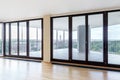 Modern white empty loft apartment interior with parquet floor and panoramic windows, Overlooking the metropolis city Royalty Free Stock Photo