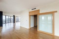 Modern white empty loft apartment interior with parquet floor and panoramic windows, Overlooking the metropolis city