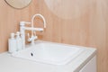 Modern white faucet and ceramic sink. Minimalist bathroom interior details Royalty Free Stock Photo