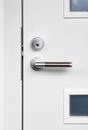 Modern white front door handle and lock Royalty Free Stock Photo