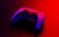 Modern white gamepad illuminated red and blue on a dark background. Royalty Free Stock Photo