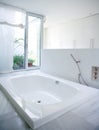 Modern white house bathroom bathtub with courtyard skylight Royalty Free Stock Photo