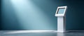 Modern white interactive kiosk with touchscreen in empty room illuminated by spotlight on blue wall background Royalty Free Stock Photo