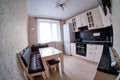 Modern white kitchen with black countertop, sink, cupboards and window fisheye photo