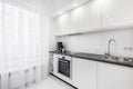 White kitchen with black countertop Royalty Free Stock Photo