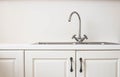 Modern white kitchen with wood accents and iron sink close-up retro design Royalty Free Stock Photo
