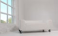 Modern White leather sofa with wheels in white room and window Royalty Free Stock Photo