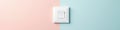 Modern white light switch against pastel painted wall, object, electrical outlet Royalty Free Stock Photo