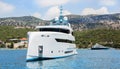 Modern white mega yacht in the blue sea. Rich people on holidays.