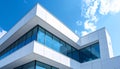 Modern White Office Building Facade with Blue Sky and Clouds Reflected in Windows architecture Royalty Free Stock Photo