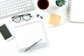 Modern white office desk table with computer, calendar, notebook, tree, glasses and cup of coffee. Top view with copy space Royalty Free Stock Photo