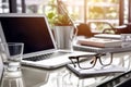 Modern white office desk table with laptop, notebook, coffe, glasses