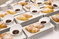 Modern white plates with plain croissants with chocolate sauce.