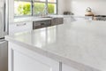 Modern white quartz kitchen countertop with double sink and faucet design Royalty Free Stock Photo