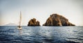 Modern white sailboat sailing slowly in rippling sea