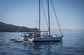 Modern white sailboat sailing slowly in rippling sea