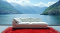 Modern white sectional sofa on red rug overlooking lake and mountains Royalty Free Stock Photo