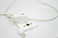 Modern white smartphone and phone charge with power cord isolated over white Royalty Free Stock Photo