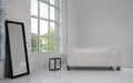 Modern white sofa and large black framed mirror in white minimalistic room with big window Royalty Free Stock Photo