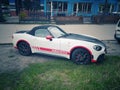 White sport car Fiat 124 Spider Abarth coupe parked