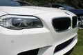 Modern white sports sedan front detail