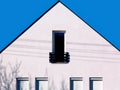 modern white stucco house exterior detail. small french balcony and glass door. home ownership