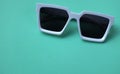 Fatlay Modern white sunglasses fashion on pastel green background.