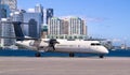 Modern white turboprop airliner with black six-bladed propellers sitting on the tarmac of Toronto City Airport separated Royalty Free Stock Photo