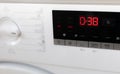 Modern white washing machine front panel with display.