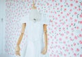 Modern white wedding dress on a mannequin with blured flower background Royalty Free Stock Photo