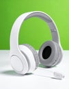 Modern White Wireless Headset on Green Background Royalty Free Stock Photo