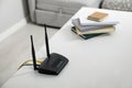 Modern Wi-Fi router on white table in room. Space for text Royalty Free Stock Photo