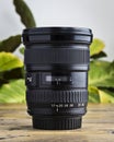 Modern wide angle DSLR lens on a wooden table Royalty Free Stock Photo