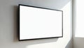 Modern widescreen display monitor with blank white panel screen mounted on light wall. Sunlight streams from window, casting Royalty Free Stock Photo
