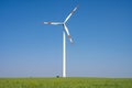Modern wind turbine in front of a blue sky Royalty Free Stock Photo