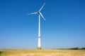 Modern wind turbine in a grain field Royalty Free Stock Photo