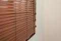 Modern window with closed stylish wooden blinds. Space for text Royalty Free Stock Photo