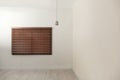 Modern window with closed stylish wooden blinds. Space for text Royalty Free Stock Photo