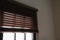Modern window with stylish wooden blinds Royalty Free Stock Photo
